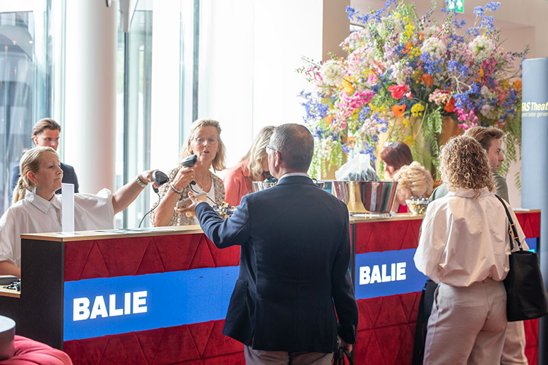 Hostess scans QR code on visitor's phone.