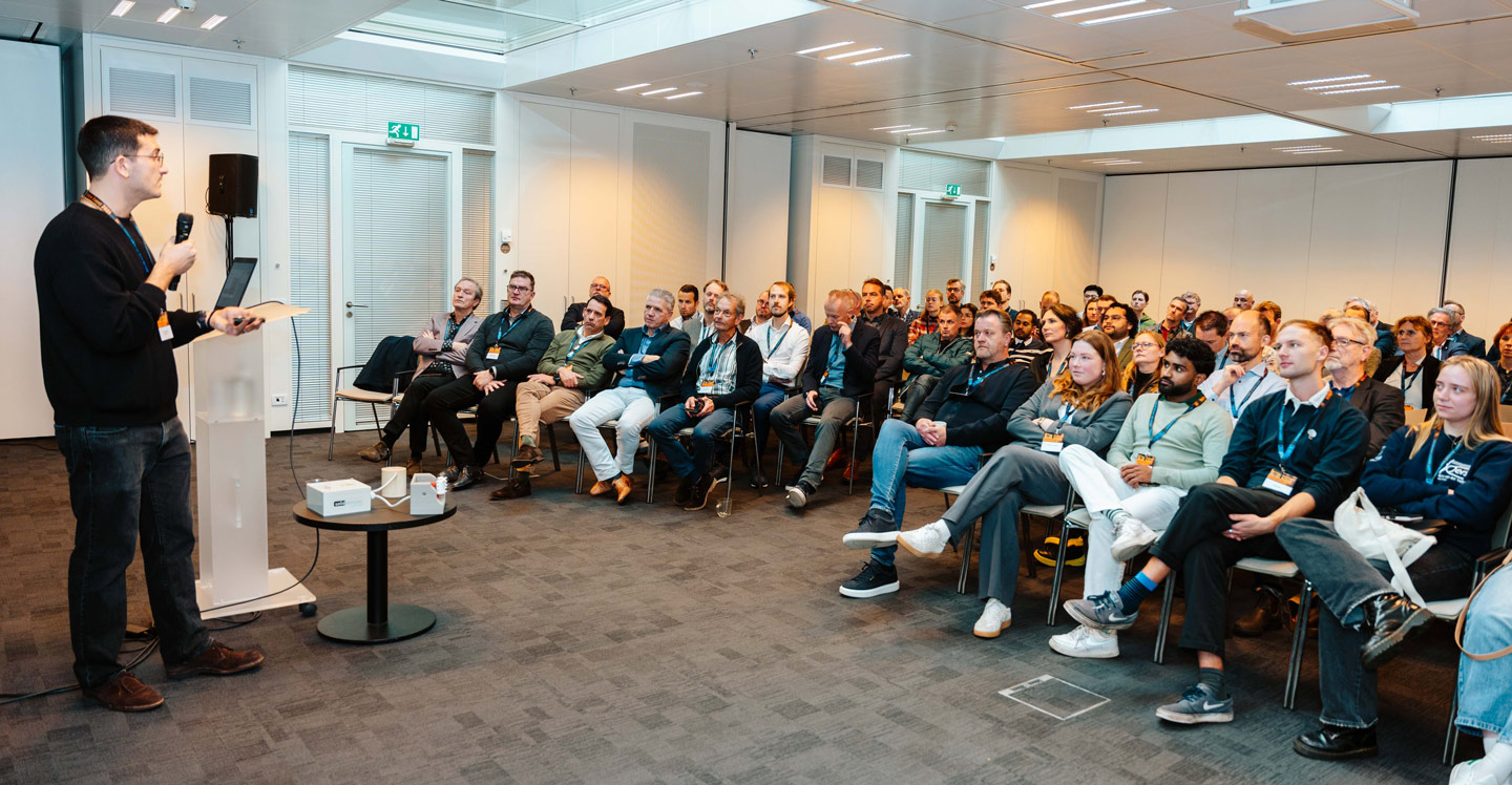 Full room with participants at a session
